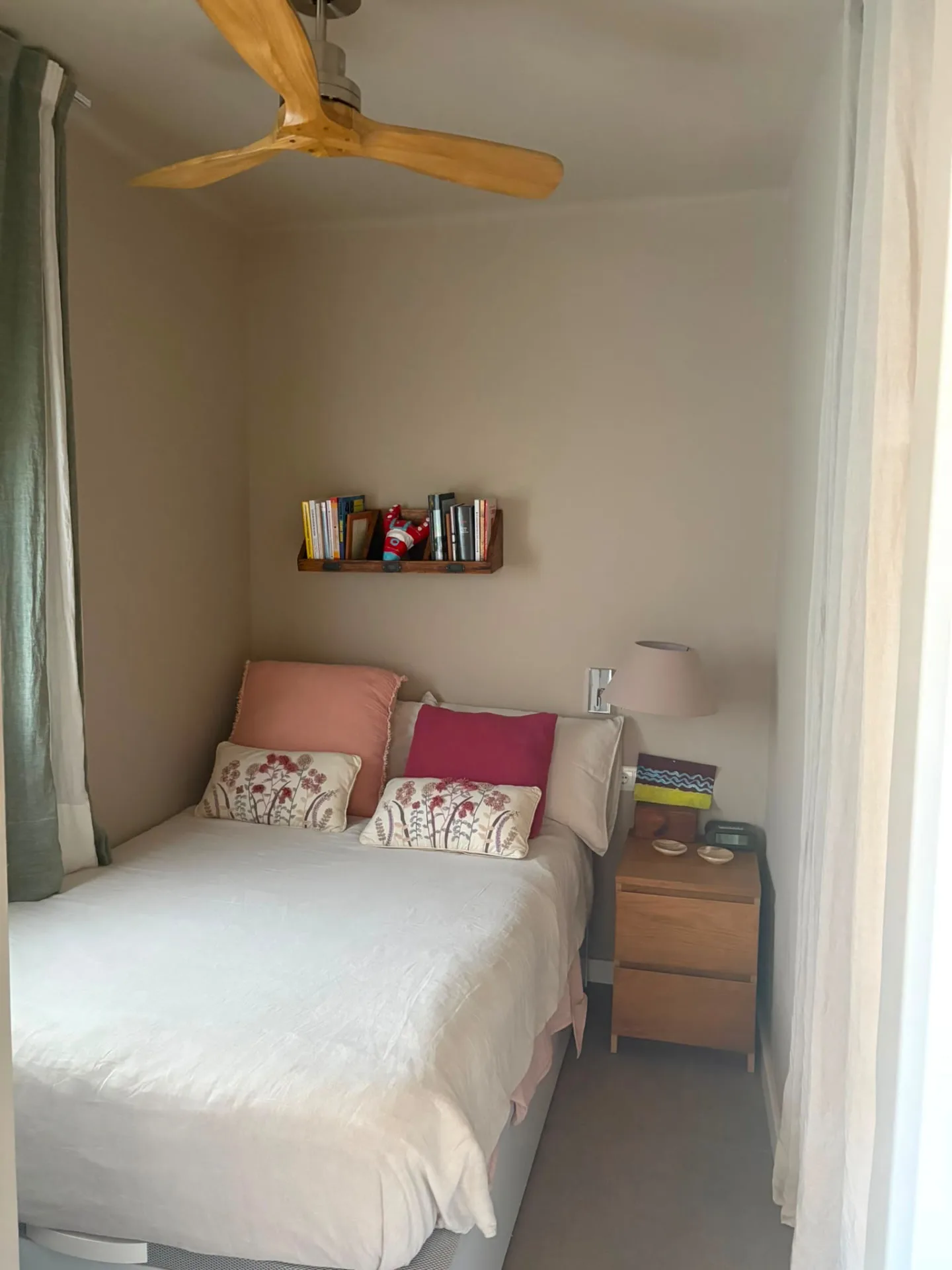 Small bedroom with a wooden ceiling fan, linen bedding and a wall-mounted book shelf — Mediterranean Home on the Costa Brava