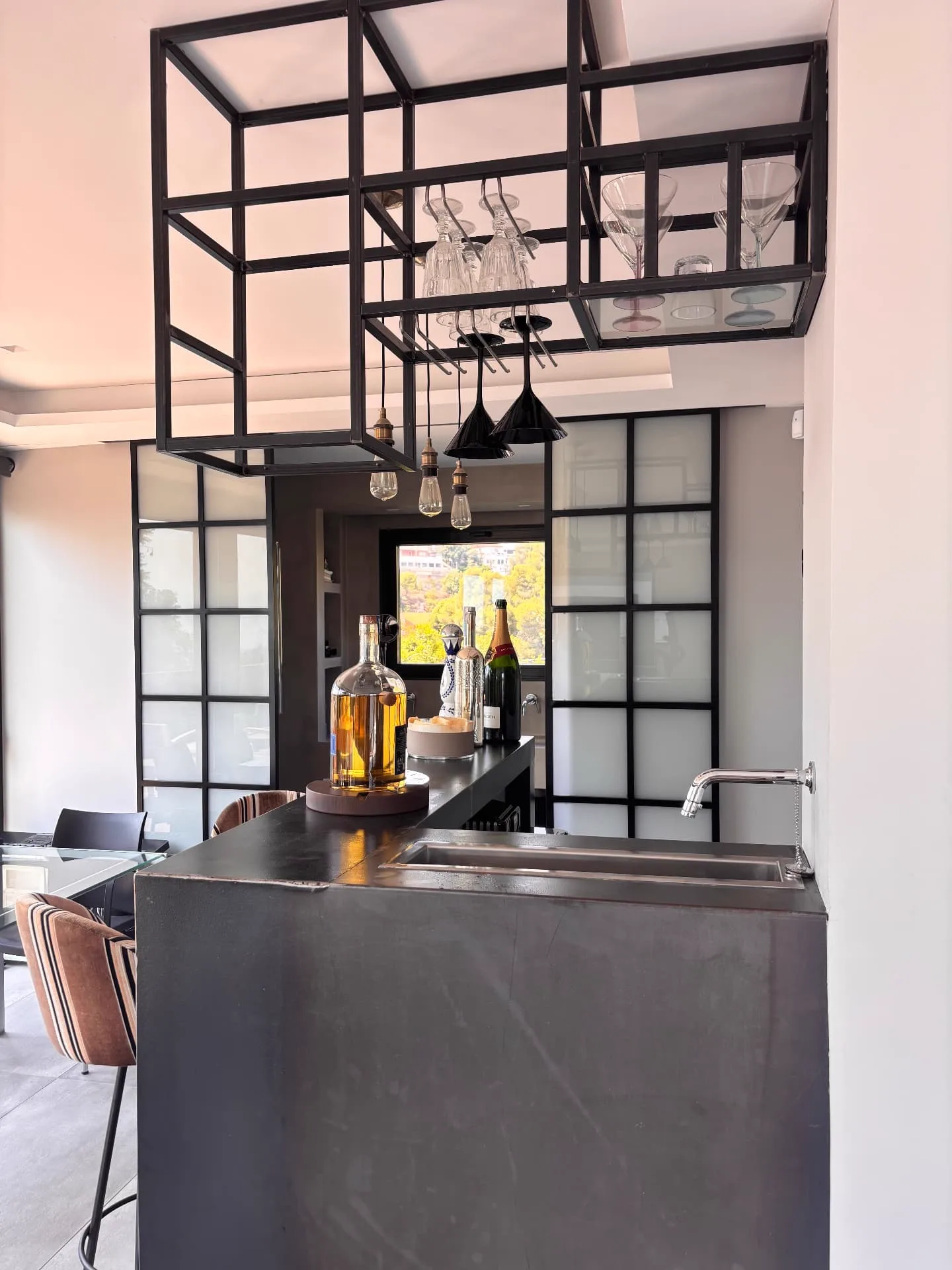 Complete home bar with suspended glass rack, integrated sink and connection to the bathroom — Christina’s Home