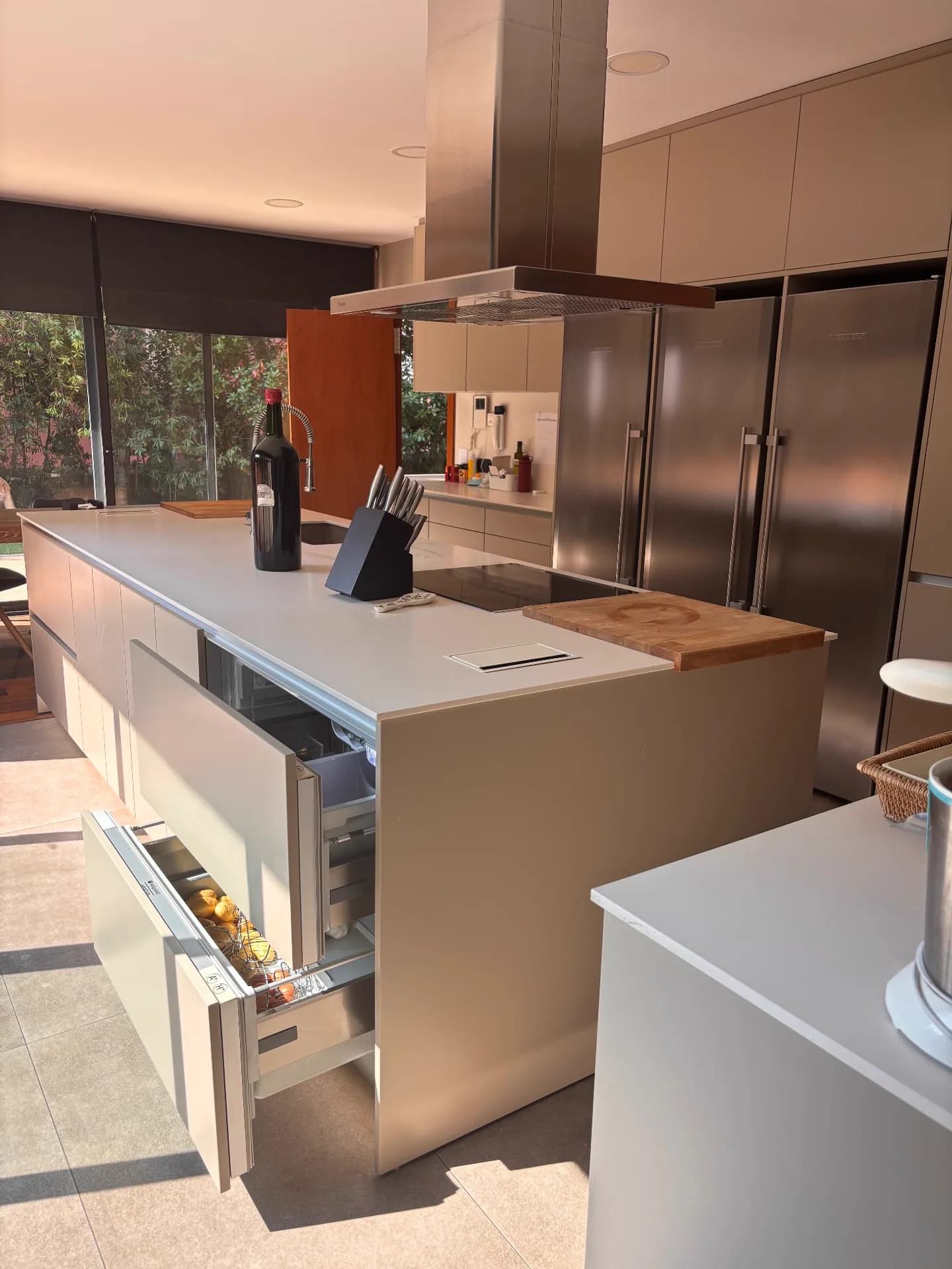 Kitchen island with integrated refrigerated drawers open — Christina’s Home