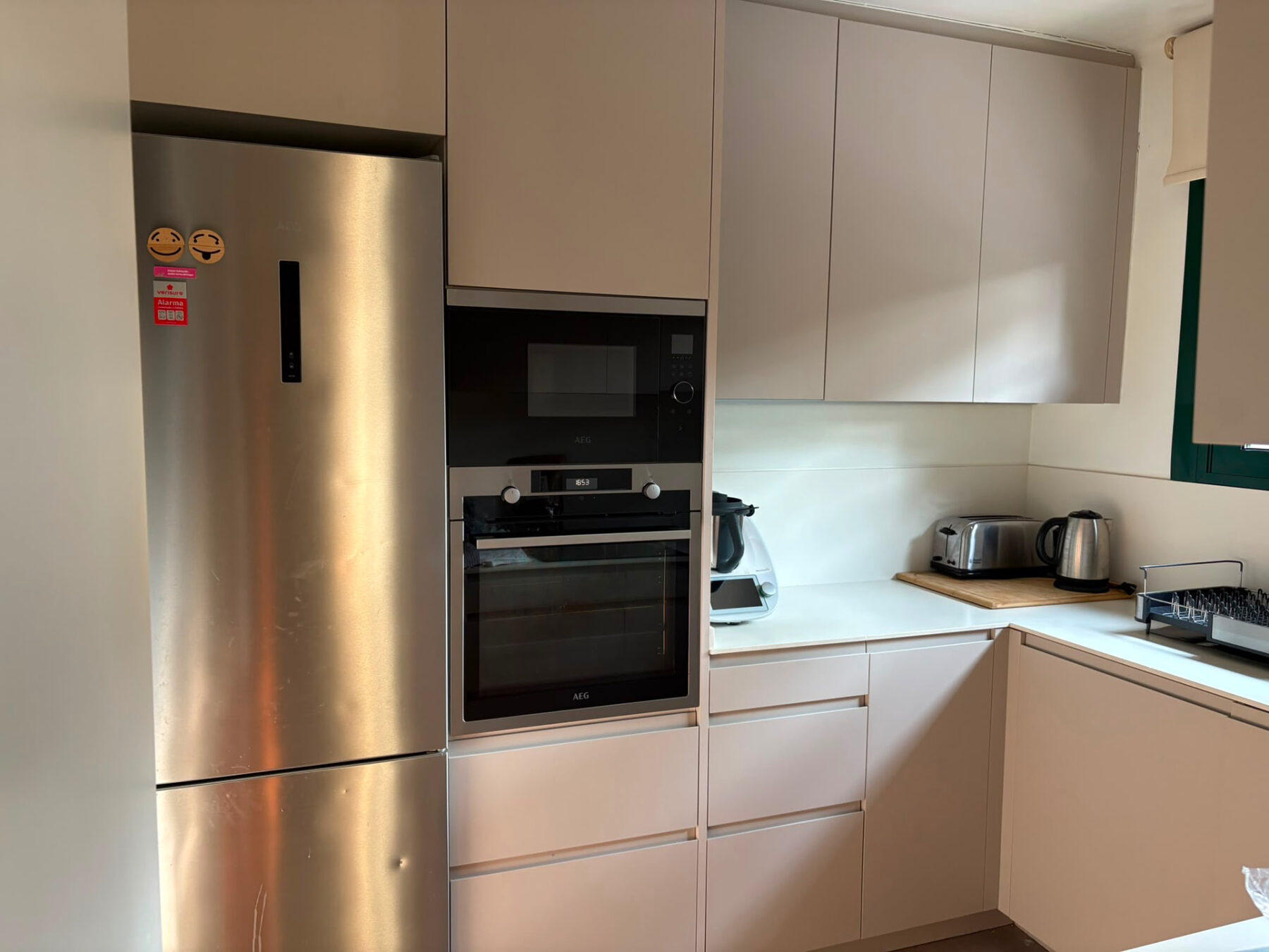 Kitchen with light taupe cabinetry and stainless steel appliances — Mediterranean Home on the Costa Brava